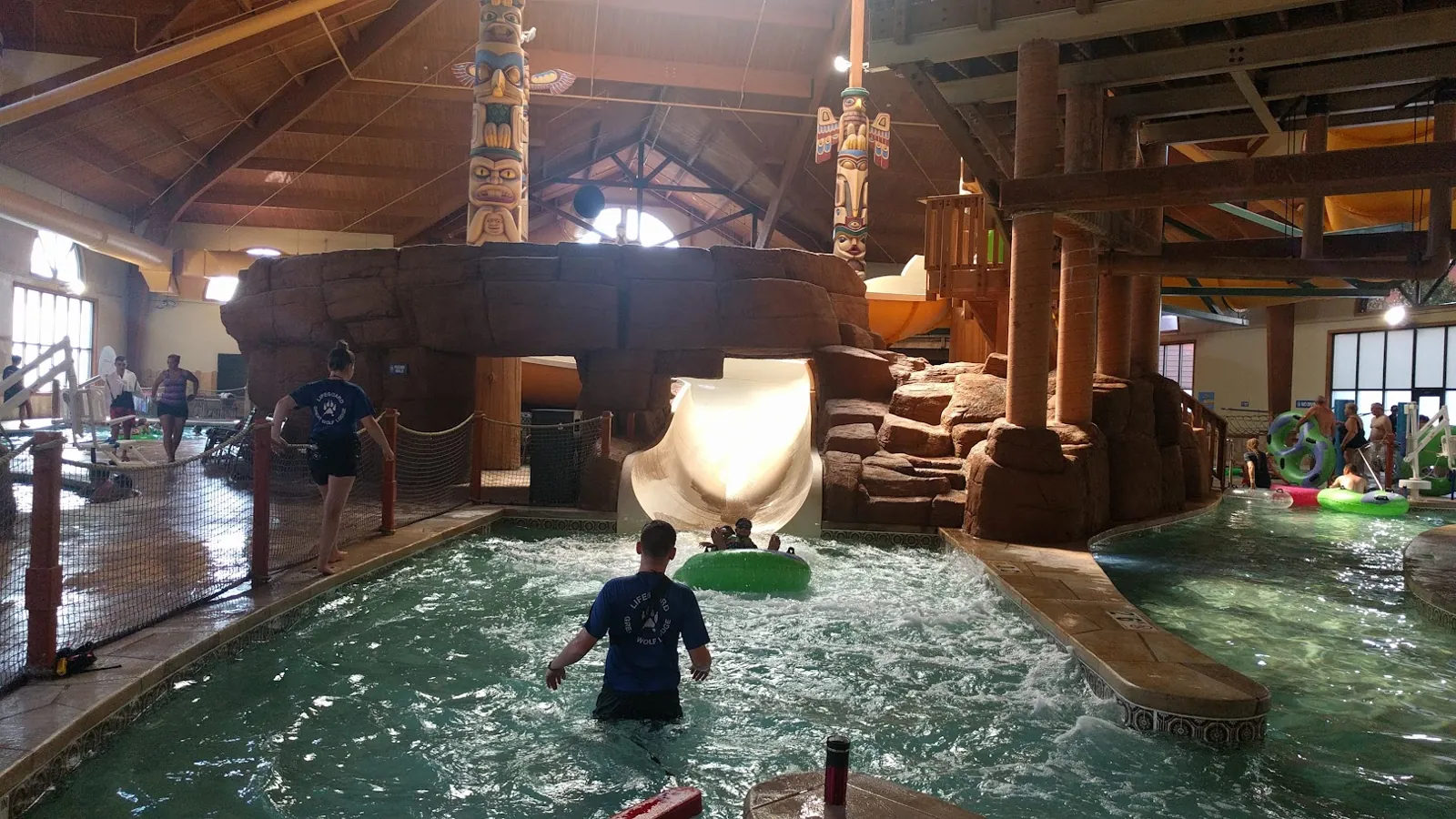 A rider in a green tube splashing down at the bottom of a slide at Great Wolf Lodge