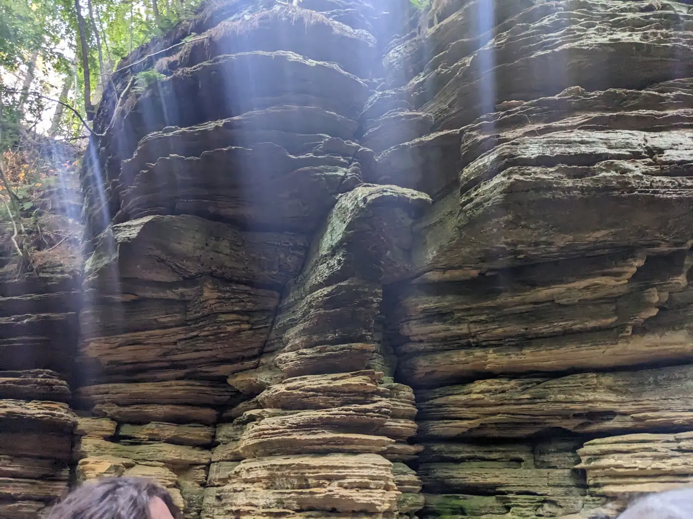Layered sandstone walls lit by sunbeams at Lost Canyon