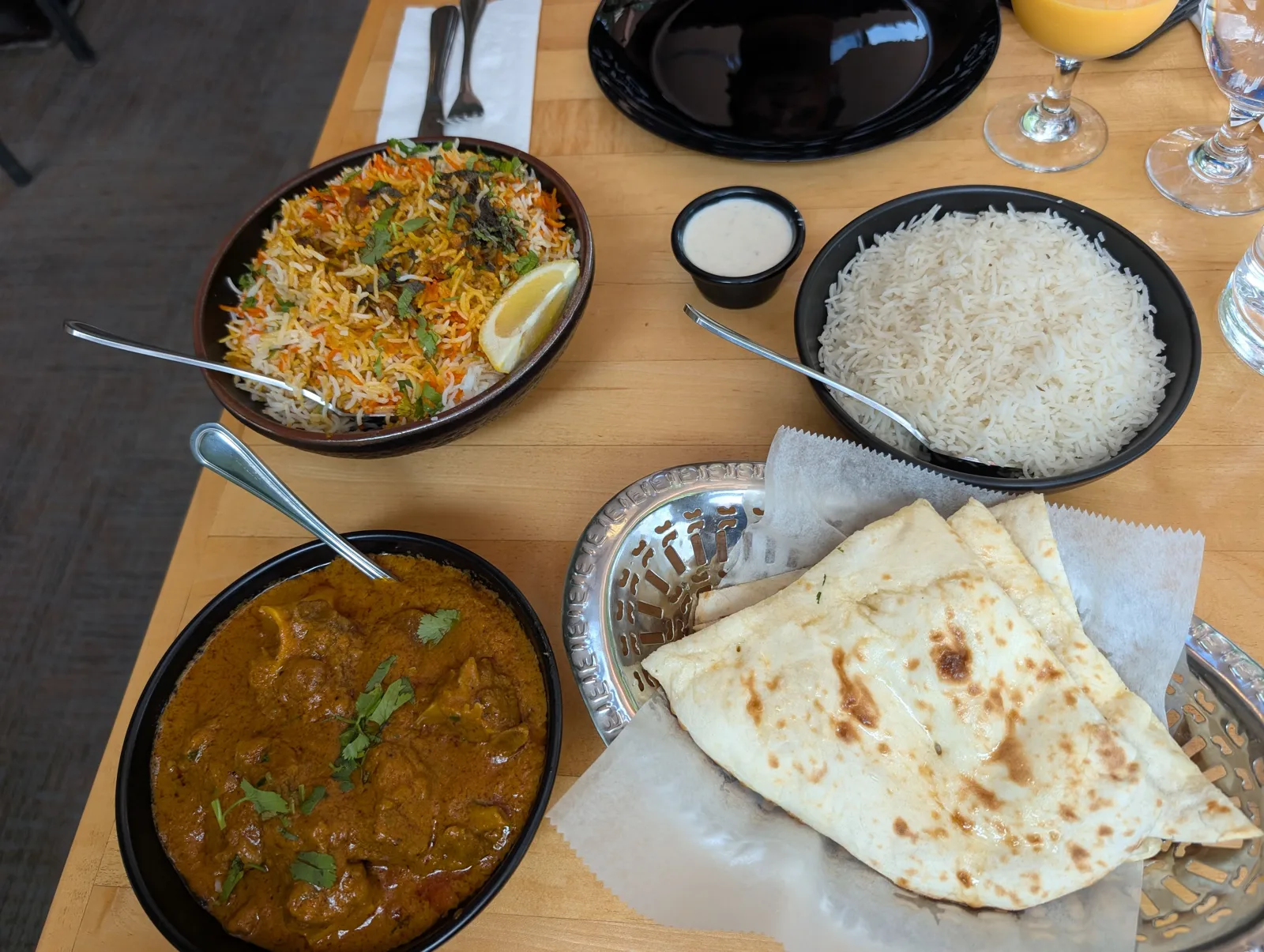 Biryani, goat curry, naan and rice on the table at Swagat Indian Cuisine in Wisconsin Dells