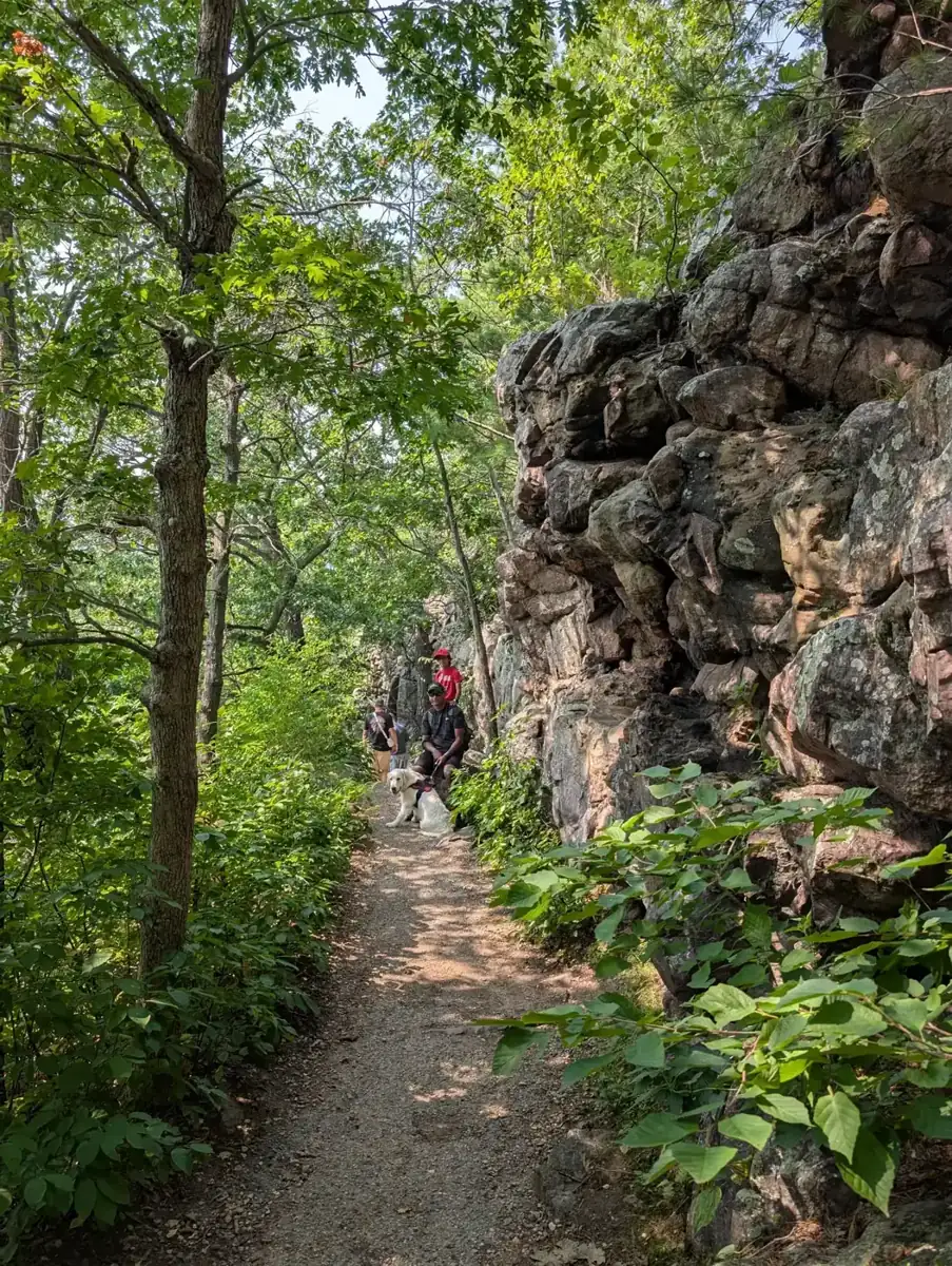 A dirt trail running below a quartzite rock wall at Devil's Lake