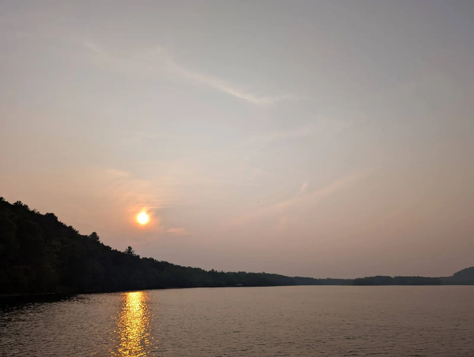 The sun setting over the Wisconsin River from an evening Upper Dells boat tour