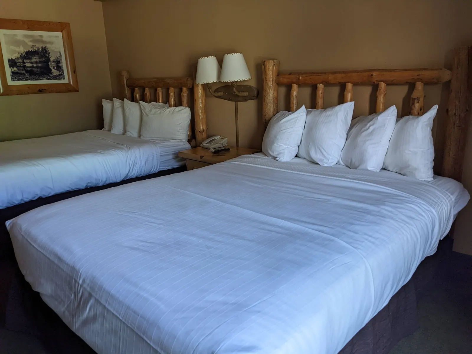 A Wilderness Hotel room with two log-frame queen beds