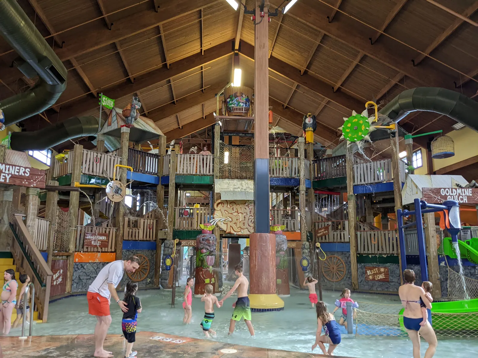 A multi-level kids play structure inside the indoor waterpark at Wilderness